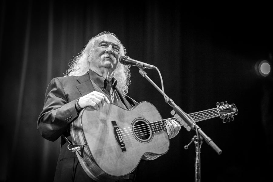 David Crosby singing at the microphone with an acoustic guitar, in black and white, Tarrytown Music Hall