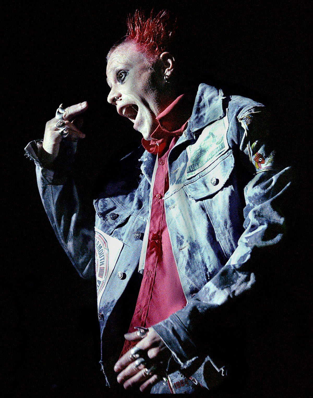Keith Flint of The Prodigy mid-shout in a denim jacket under hard stage light, The Mayan Theatre, Los Angeles