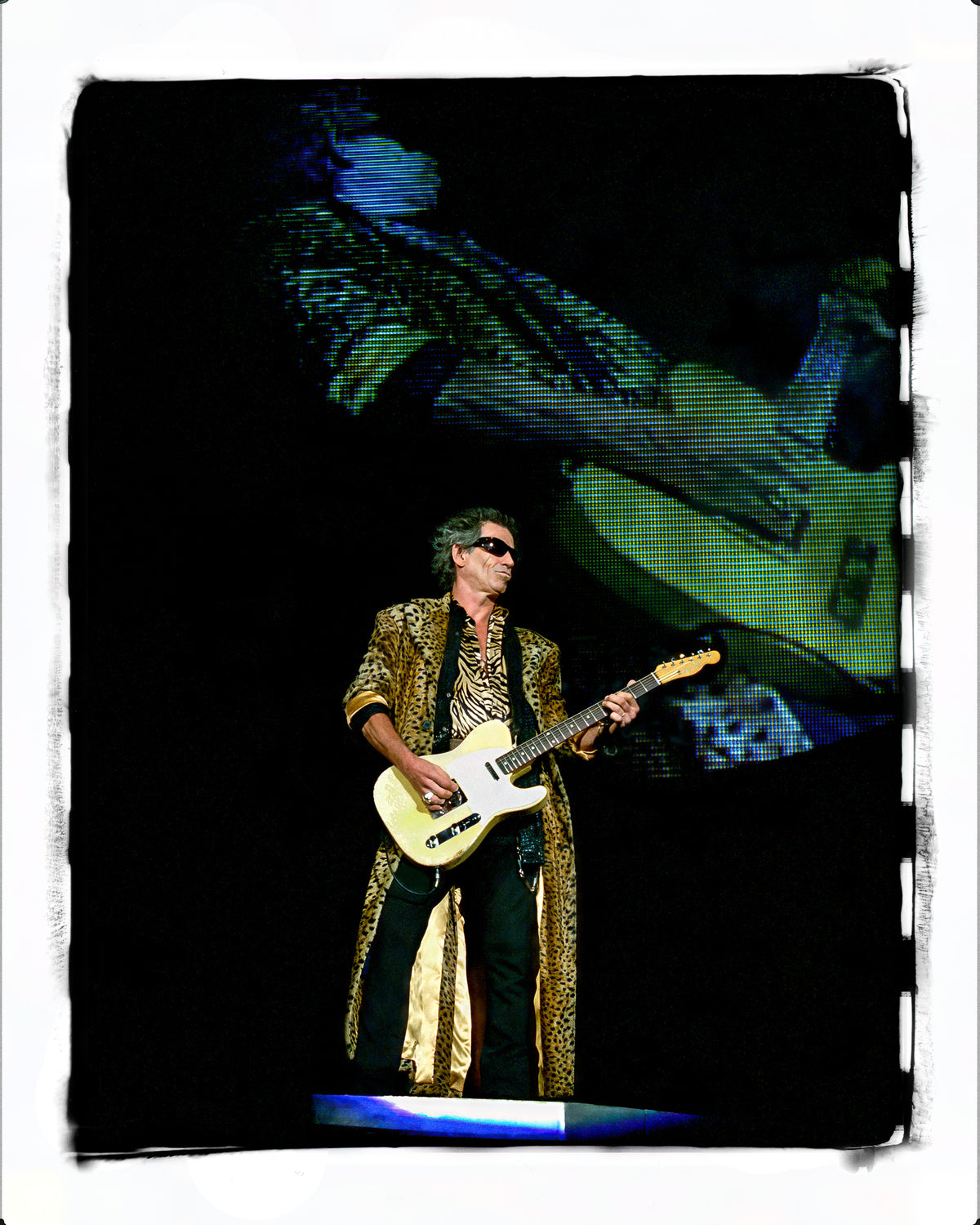 Keith Richards of The Rolling Stones playing in a long green coat, Rose Bowl, Pasadena