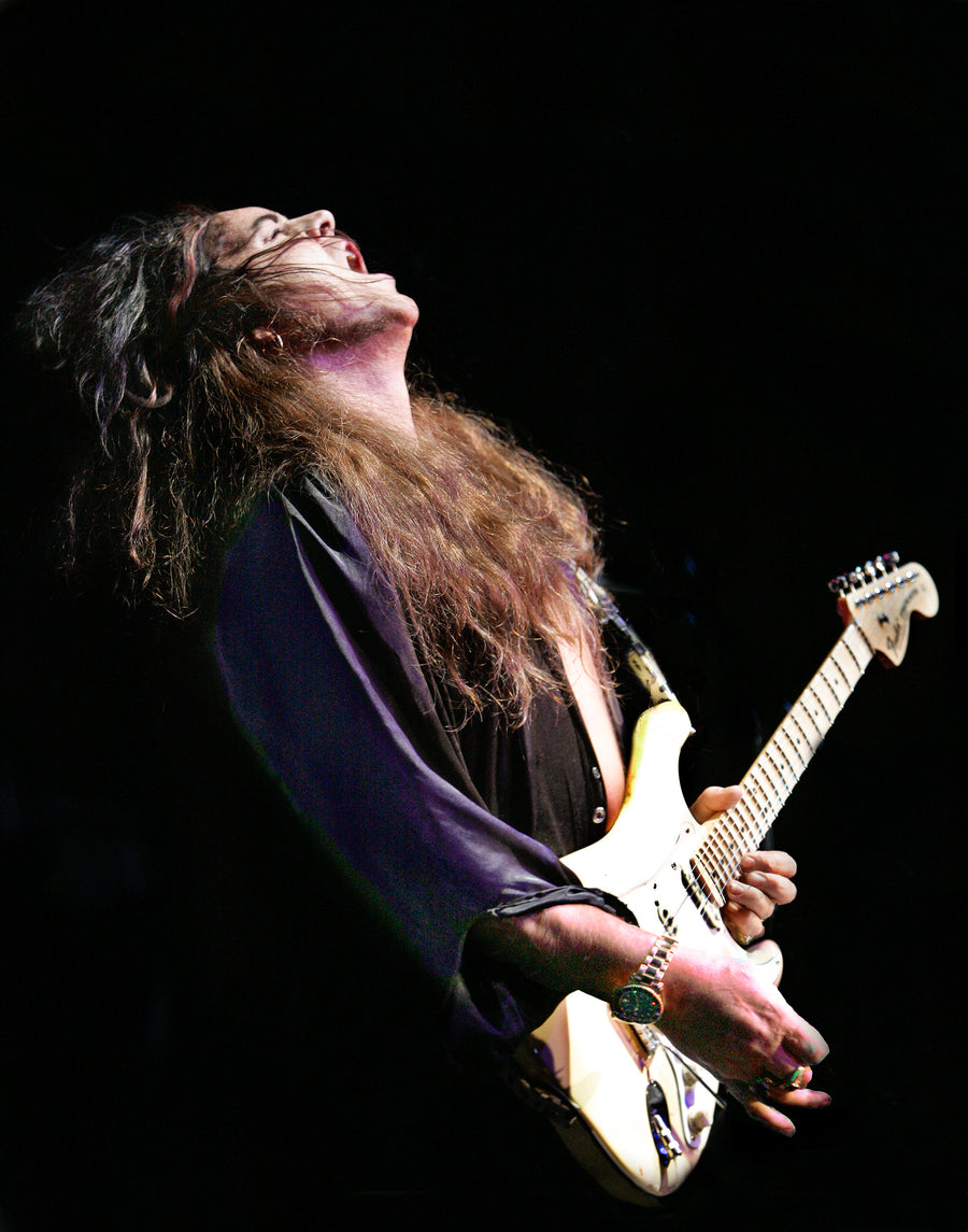 Yngwie Malmsteen head thrown back mid-solo on stage, Anaheim